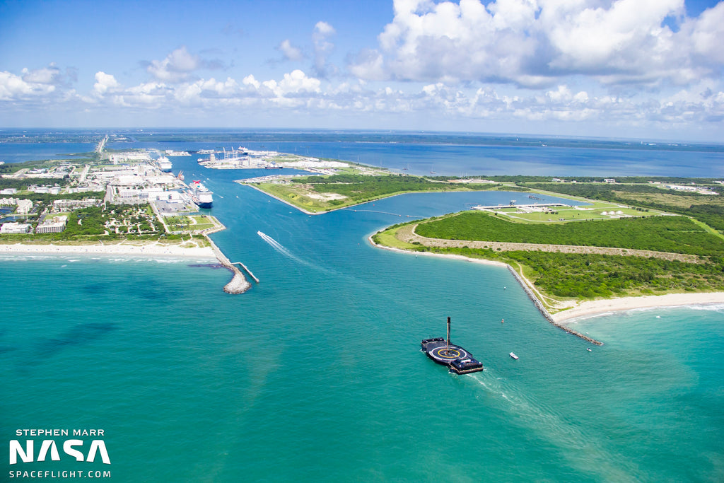 “A Shortfall of Gravitas” w/ landed F9 booster entering Port Canaveral