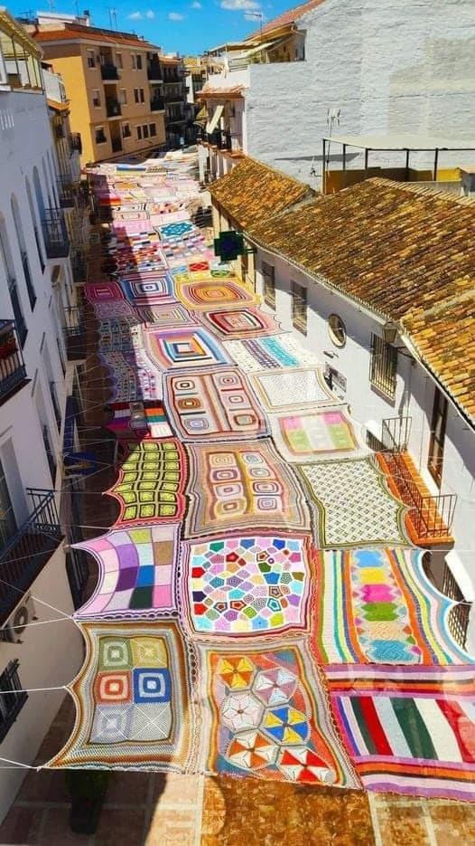 Malaga, Spain where the women who lived there crocheted and put together this shadow-giving miracle