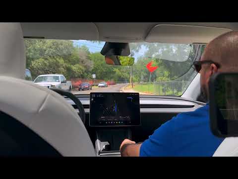 Tesla Robotaxi stops for a pedestrian who walked out onto the street near Zilker Park in Austin, TX
