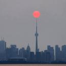 Smoky skies make for rare bright red sun in Toronto and the photos are surreal